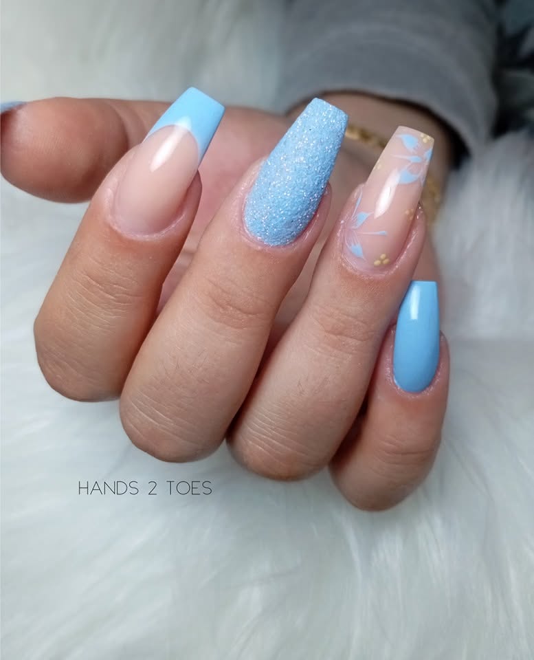 Baby blue French nails with floral and glitter accents